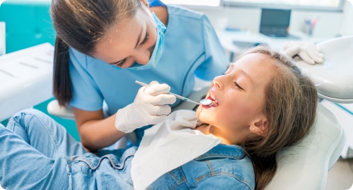 dental assistant working in child's mouth